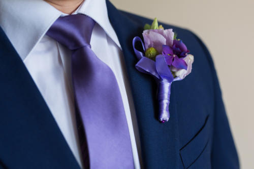 Boutonniere on trendy groom at wedding