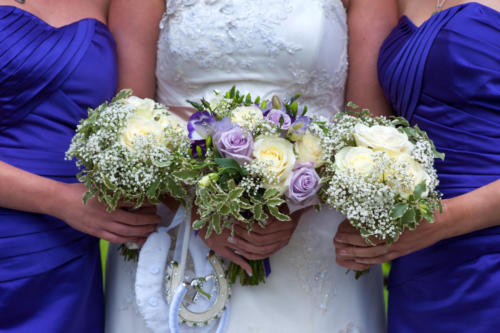 bride and bridesmaids with wedding bouquets