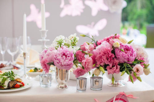 Beautiful bright bouquet of peony on the wedding table in vase